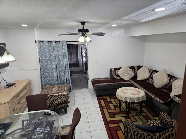 living area with a textured ceiling, recessed lighting, light tile patterned flooring, and a ceiling fan