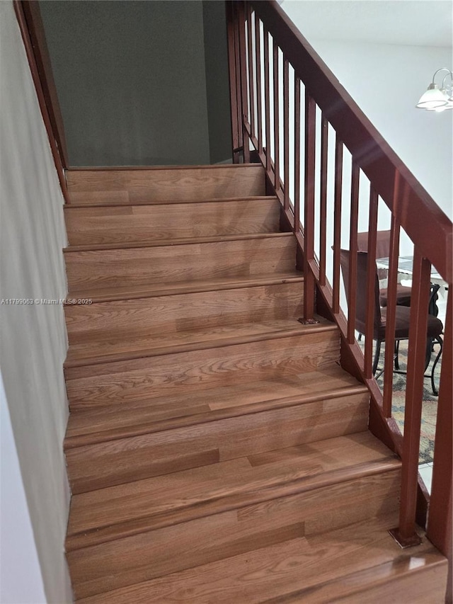 staircase featuring wood finished floors