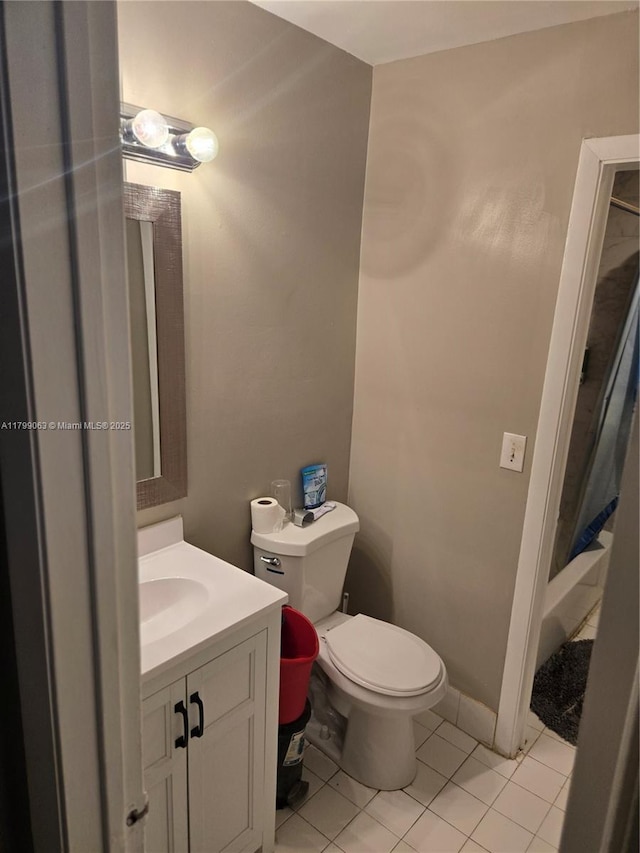 full bath featuring vanity, toilet, tile patterned flooring, and a shower