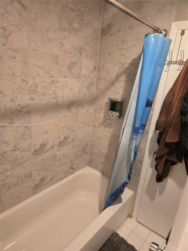 full bath featuring tile patterned flooring and shower / bath combo