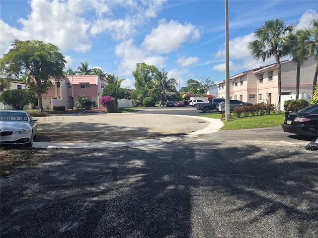 view of asphalt road with a residential view