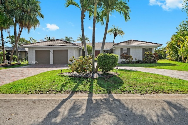 3215 NW 114th Ln, Coral Springs, FL 33065 - single story home with a tile roof, decorative driveway, a front yard, an attached garage, and brick siding