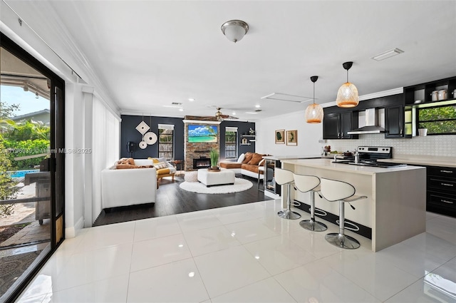 3215 NW 114th Ln, Coral Springs, FL 33065 - kitchen with wall chimney range hood, range with electric cooktop, dark cabinets, light countertops, and backsplash