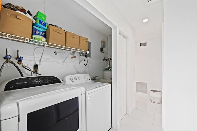3215 NW 114th Ln, Coral Springs, FL 33065 - laundry room featuring independent washer and dryer, light tile patterned floors, and water heater