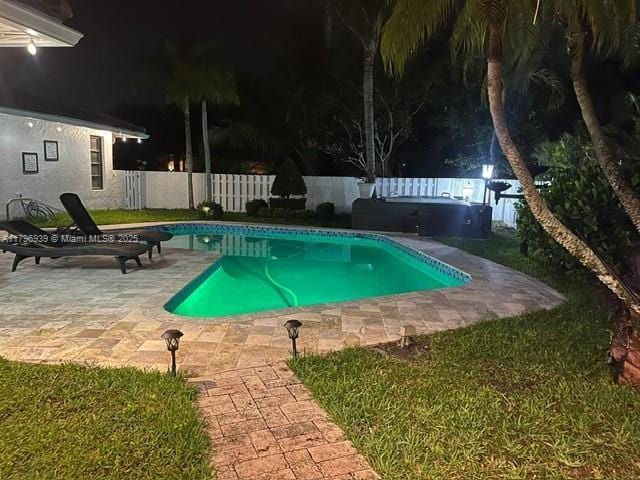 3215 NW 114th Ln, Coral Springs, FL 33065 - pool at night with a fenced backyard and a patio area