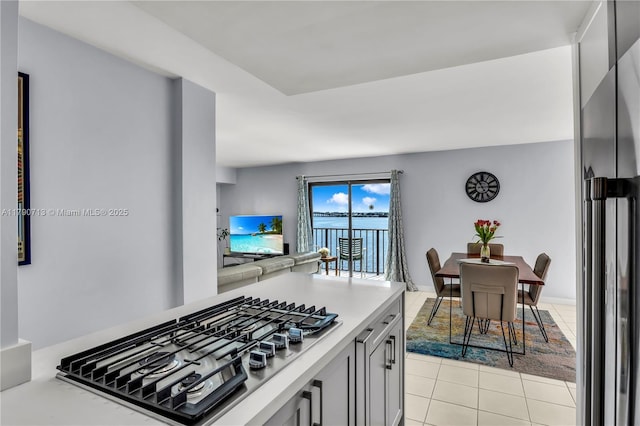 2201 Brickell Ave Unit 77, Miami, FL 33129 - kitchen featuring stainless steel appliances, light tile patterned floors, light countertops, and open floor plan