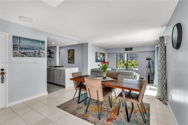 2201 Brickell Ave Unit 77, Miami, FL 33129 - dining space with light tile patterned flooring and baseboards