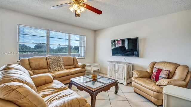 3087 Newport S Unit 3087, Deerfield Beach, FL 33442 - living area featuring a textured ceiling, light tile patterned floors, and a ceiling fan