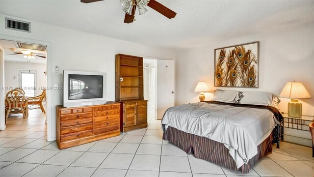 3087 Newport S Unit 3087, Deerfield Beach, FL 33442 - bedroom with light tile patterned flooring, ceiling fan, and attic access