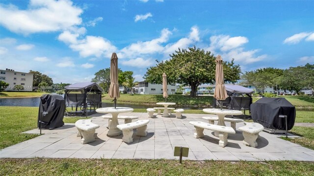 3087 Newport S Unit 3087, Deerfield Beach, FL 33442 - view of patio / terrace with grilling area, a gazebo, and a water view