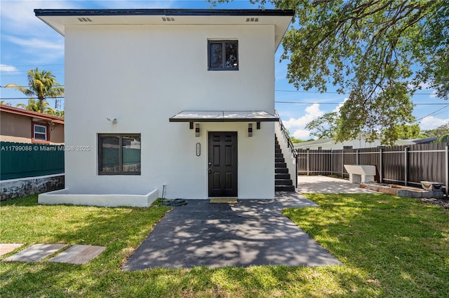 1824 NW 47th St, Miami, FL 33142 - view of front of home with stucco siding, a patio area, and stairway