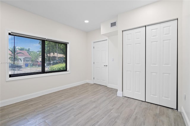 1824 NW 47th St, Miami, FL 33142 - unfurnished bedroom with multiple windows, light wood-style floors, baseboards, and recessed lighting