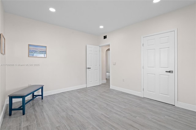 1824 NW 47th St, Miami, FL 33142 - unfurnished bedroom featuring arched walkways, baseboards, light wood-style floors, and recessed lighting