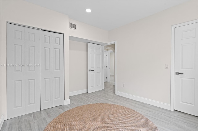 1824 NW 47th St, Miami, FL 33142 - unfurnished bedroom featuring light wood-style flooring, a closet, baseboards, arched walkways, and recessed lighting