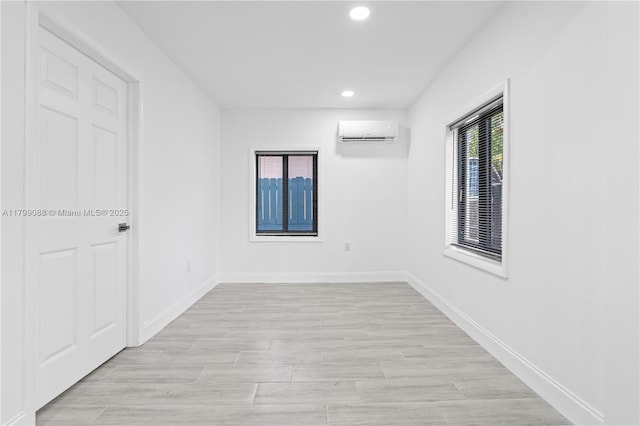 1824 NW 47th St, Miami, FL 33142 - unfurnished room featuring a wall unit AC, recessed lighting, baseboards, and light wood-type flooring