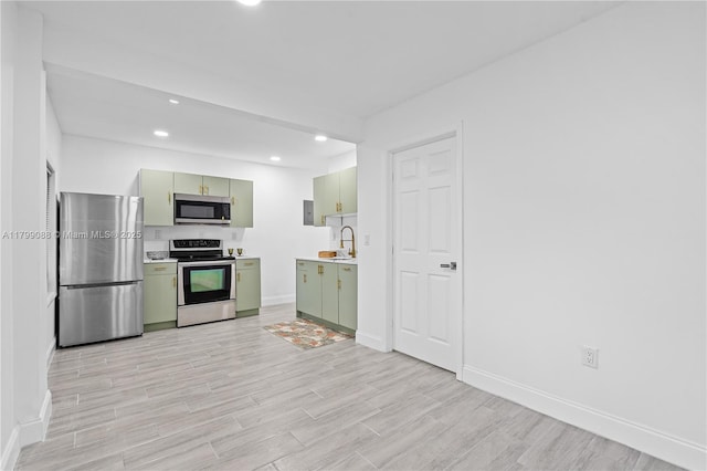 1824 NW 47th St, Miami, FL 33142 - kitchen with green cabinets, stainless steel appliances, a sink, light countertops, and recessed lighting