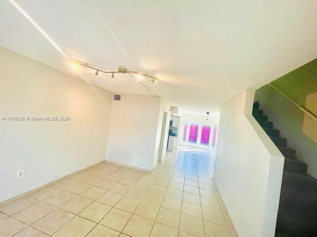 3672 SW 59th Ave Unit 7, Davie, FL 33314 - unfurnished room with light tile patterned floors, stairway, track lighting, and baseboards