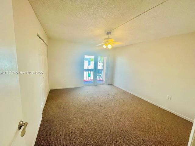 3672 SW 59th Ave Unit 7, Davie, FL 33314 - carpeted spare room featuring a ceiling fan, baseboards, and a textured ceiling