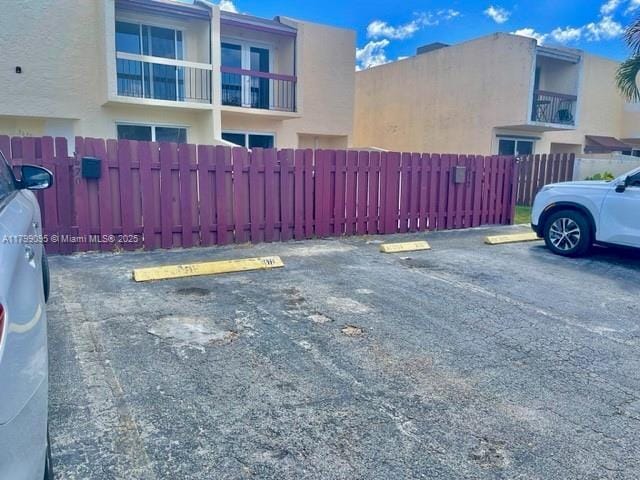 3672 SW 59th Ave Unit 7, Davie, FL 33314 - uncovered parking lot with a fenced front yard