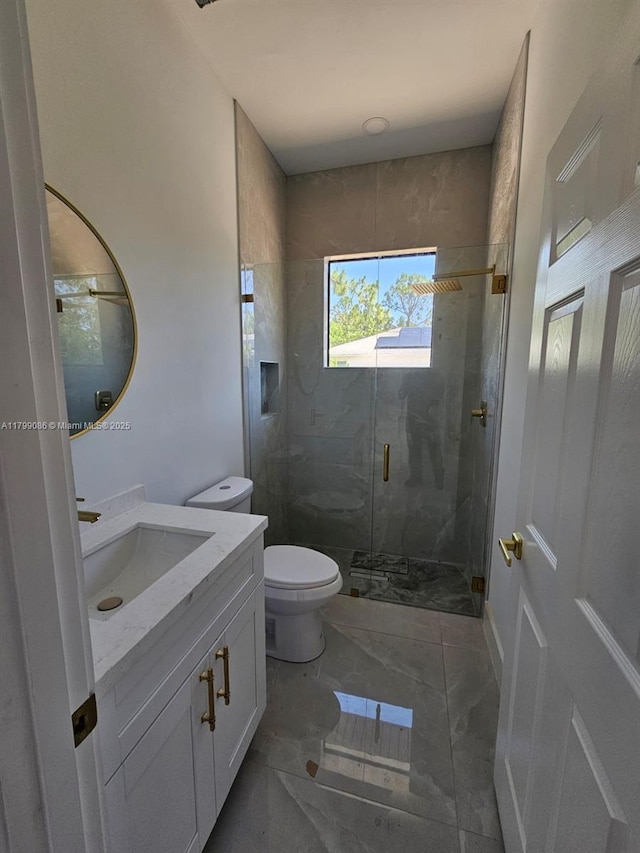 full bath with marble finish flooring, toilet, a marble finish shower, and vanity