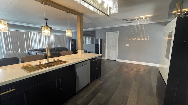 kitchen featuring stainless steel dishwasher, a sink, dark cabinetry, dark wood-type flooring, and crown molding