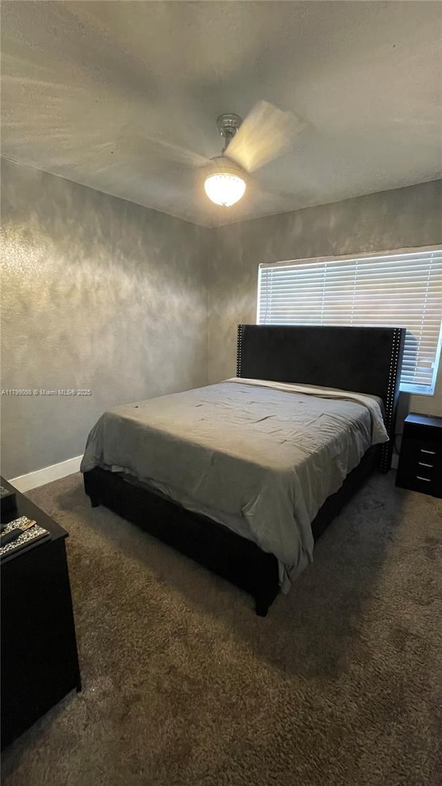 carpeted bedroom featuring ceiling fan and baseboards