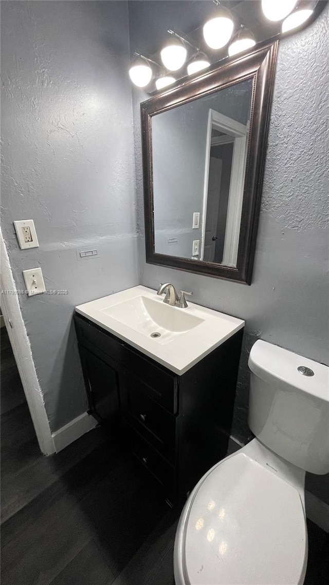 half bath with vanity and toilet