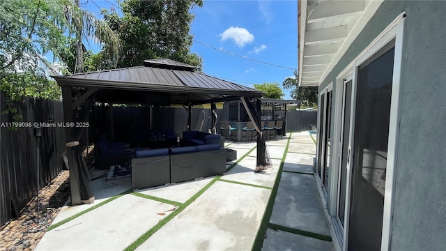 view of patio with an outdoor living space, a gazebo, and a fenced backyard
