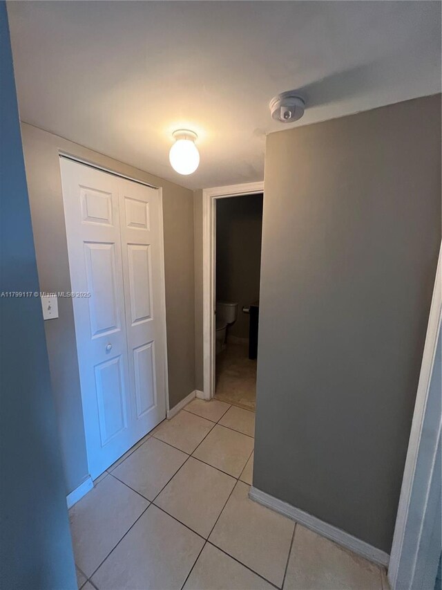 14500 SW 88th Ave Unit 245, Palmetto Bay, FL 33176 - hall with baseboards and light tile patterned flooring