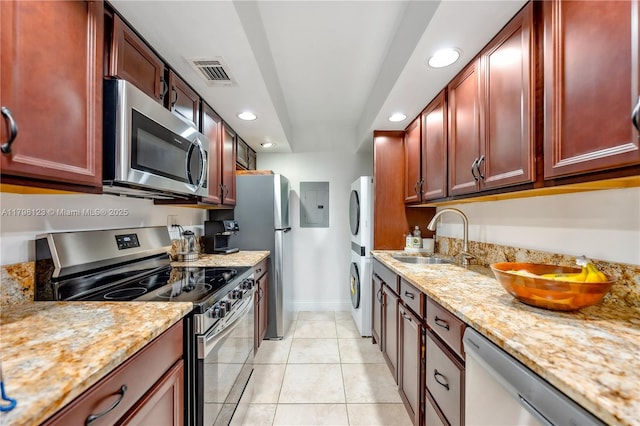 9456 SW 77th Ave Unit T6, Miami, FL 33156 - kitchen with stainless steel appliances, stacked washing machine and dryer, reddish brown cabinets, electric panel, and recessed lighting