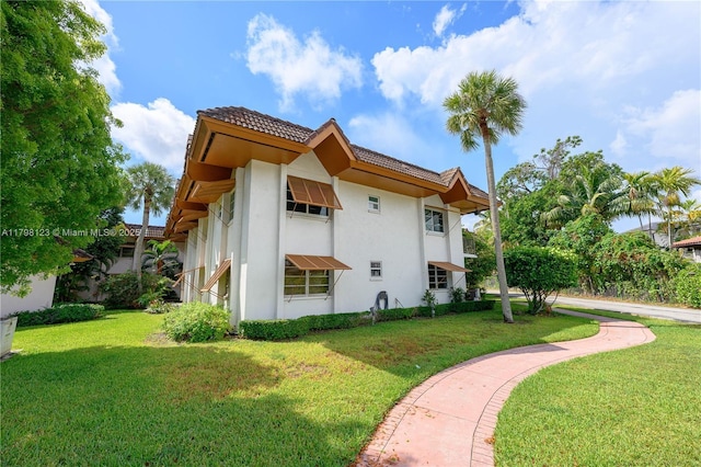 9456 SW 77th Ave Unit T6, Miami, FL 33156 - view of side of property with stucco siding, a yard, and a tile roof