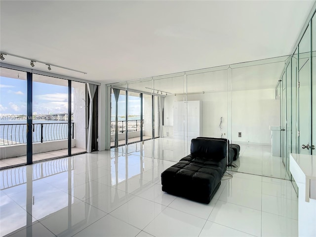 555 NE 15th St Unit 502, Miami, FL 33132 - living area featuring floor to ceiling windows, light tile patterned flooring, and a water view