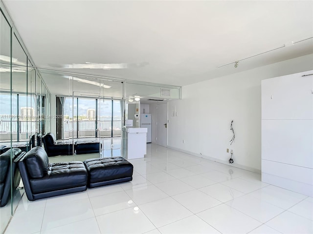 555 NE 15th St Unit 502, Miami, FL 33132 - living room featuring floor to ceiling windows, light tile patterned flooring, ceiling fan, and baseboards