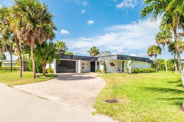 5715 Bayberry Ln, Tamarac, FL 33319 - view of front of home with an attached garage, driveway, a front lawn, and stucco siding
