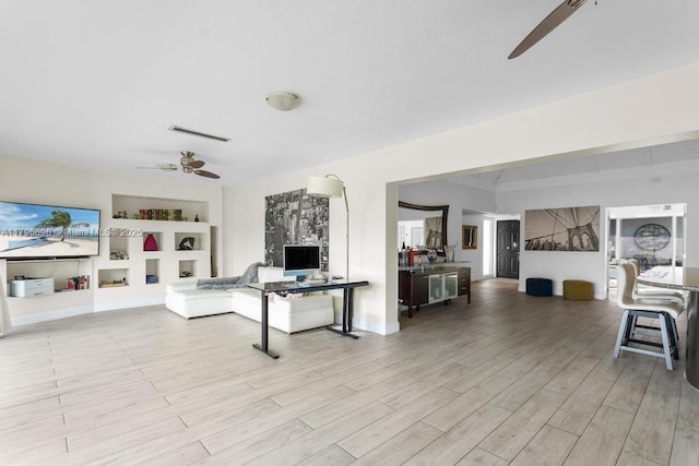 5715 Bayberry Ln, Tamarac, FL 33319 - living room featuring a ceiling fan, built in features, and light wood-style flooring