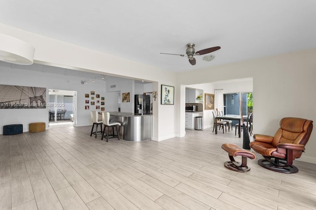 5715 Bayberry Ln, Tamarac, FL 33319 - living area featuring ceiling fan, light wood finished floors, and baseboards