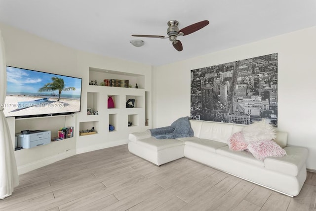 5715 Bayberry Ln, Tamarac, FL 33319 - living area featuring a ceiling fan, wood finished floors, built in shelves, and baseboards