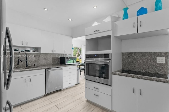 5715 Bayberry Ln, Tamarac, FL 33319 - kitchen featuring stainless steel appliances, open shelves, a sink, tasteful backsplash, and white cabinets