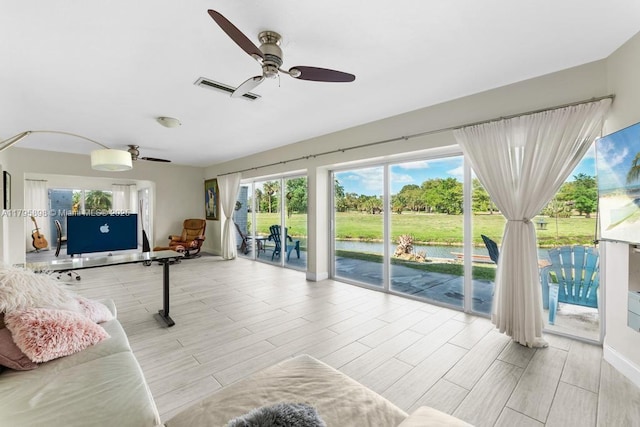 5715 Bayberry Ln, Tamarac, FL 33319 - unfurnished living room with a ceiling fan, wood finished floors, and a water view