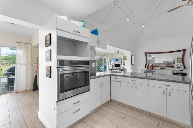 5715 Bayberry Ln, Tamarac, FL 33319 - kitchen featuring ceiling fan, oven, plenty of natural light, and high vaulted ceiling