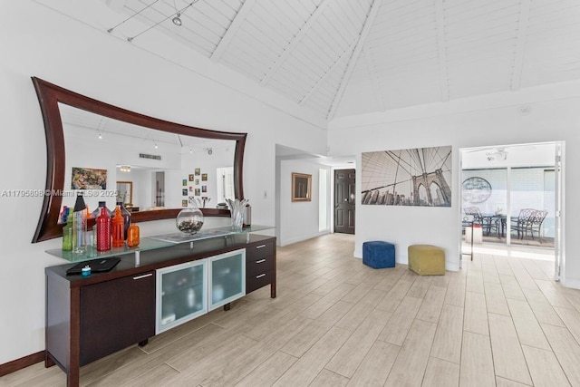 5715 Bayberry Ln, Tamarac, FL 33319 - bar area featuring high vaulted ceiling, light wood finished floors, beam ceiling, and baseboards