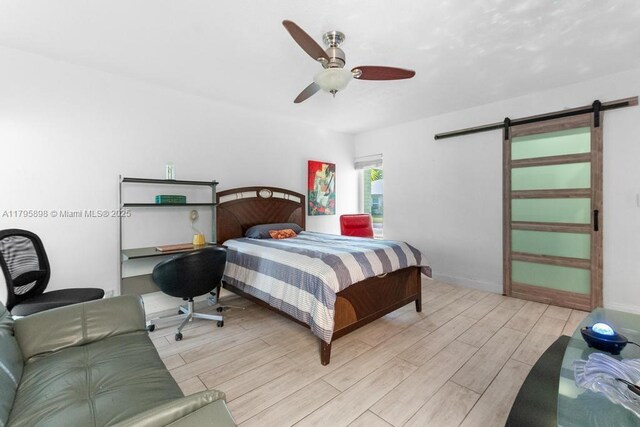 5715 Bayberry Ln, Tamarac, FL 33319 - bedroom with a barn door, light wood finished floors, and a ceiling fan