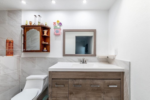 5715 Bayberry Ln, Tamarac, FL 33319 - half bathroom featuring tile walls, vanity, toilet, and recessed lighting