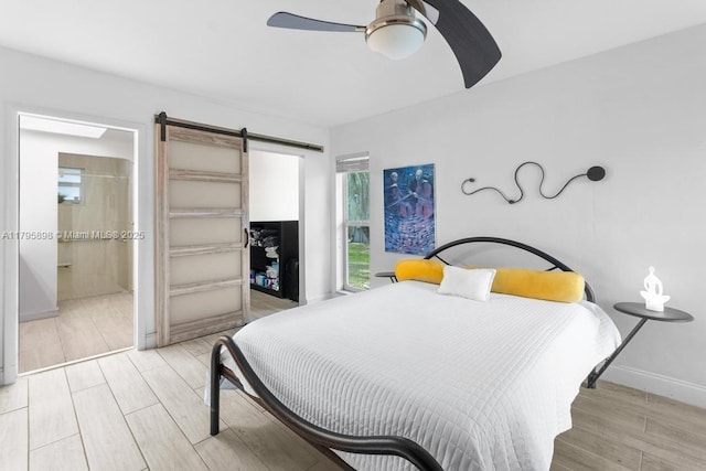 5715 Bayberry Ln, Tamarac, FL 33319 - bedroom featuring wood finished floors, a barn door, baseboards, and a ceiling fan