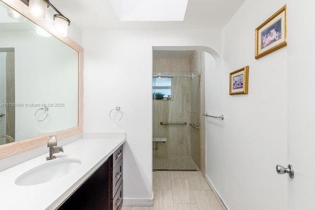 5715 Bayberry Ln, Tamarac, FL 33319 - full bath with a tile shower, baseboards, vanity, and a skylight