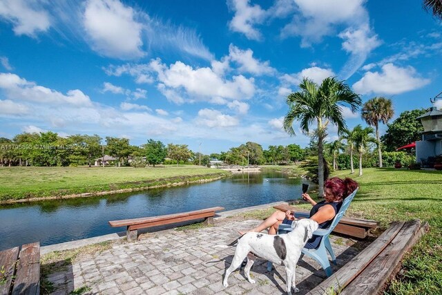 5715 Bayberry Ln, Tamarac, FL 33319 - dock area with a water view and a lawn