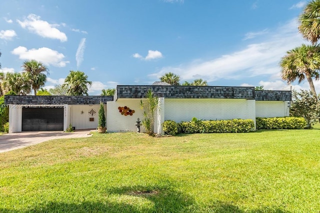5715 Bayberry Ln, Tamarac, FL 33319 - view of grassy yard with an attached garage and concrete driveway