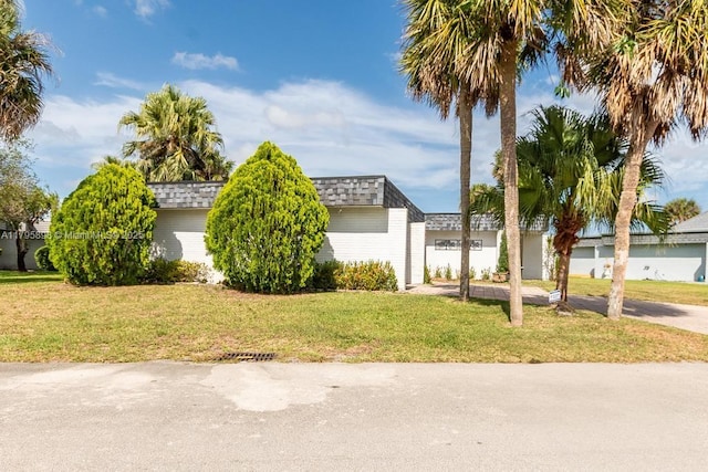 5715 Bayberry Ln, Tamarac, FL 33319 - view of side of home featuring mansard roof, a lawn, and a shingled roof