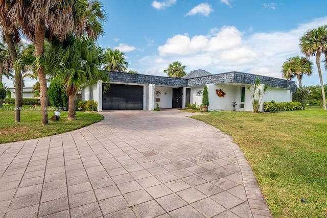 5715 Bayberry Ln, Tamarac, FL 33319 - view of front of property featuring a garage, a front lawn, driveway, and mansard roof