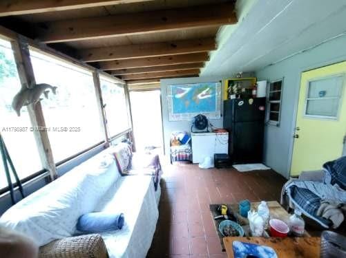2415 Garfield St, Hollywood, FL 33020 - living room with healthy amount of natural light and beamed ceiling
